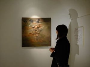 A visitor admiring The Mask painting at the Gallery Oneiro in Paris, April 2015